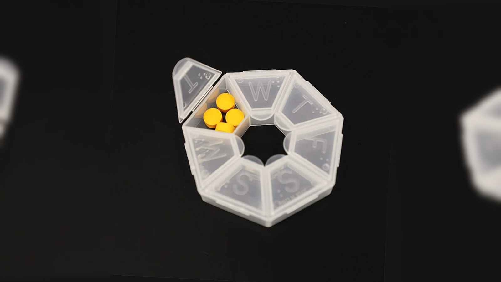 transparent weekly braille pill box with raised day-letter lids